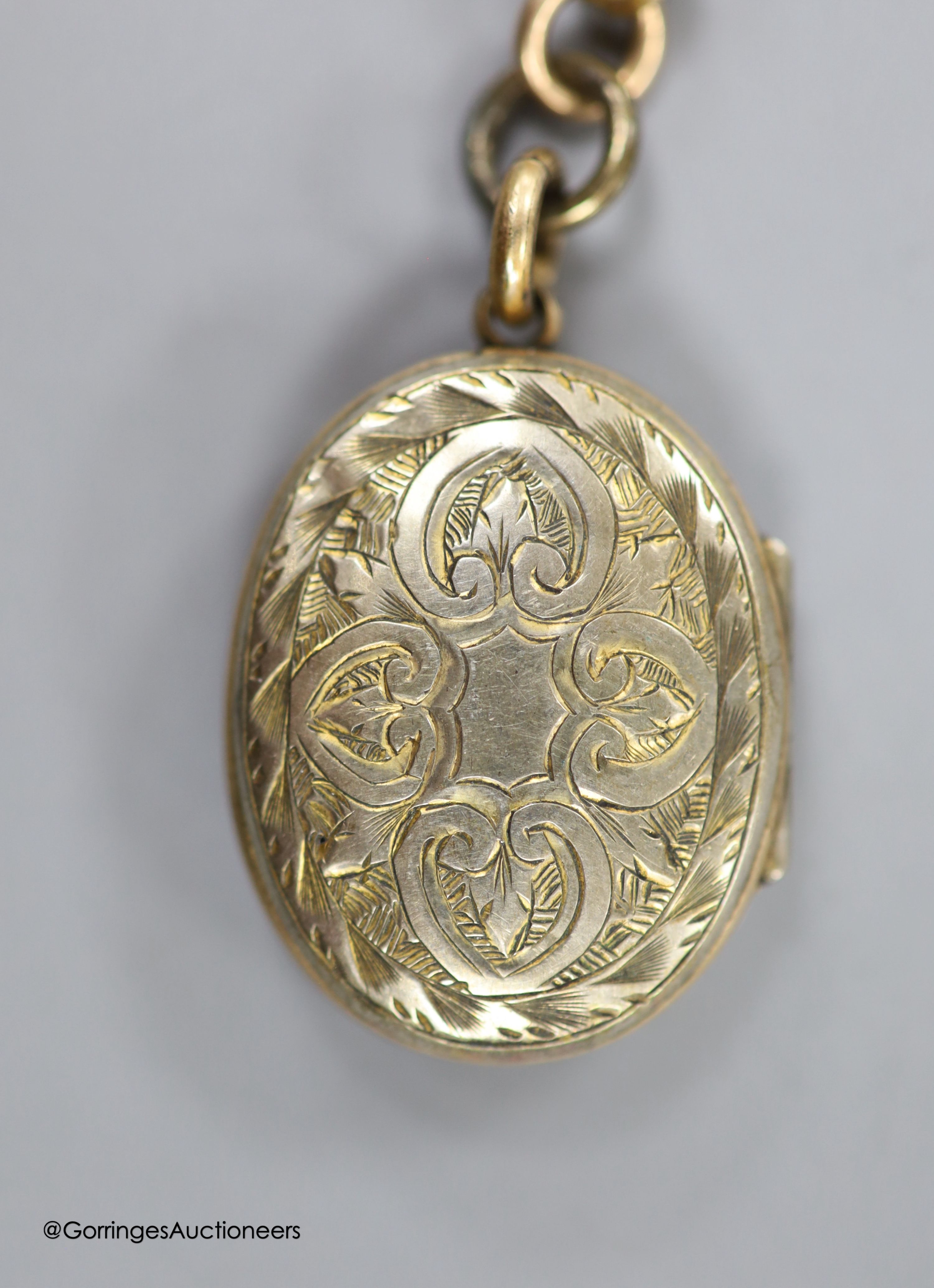 A Victorian gilt metal and enamel oval locket, 29mm, together with a fancy double link albert, stamped 9c, 34.5cm, 25 grams.